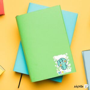 استیکر لپ تاپ پوستر روح کوچولوی سبز رنگ روی دفترچه